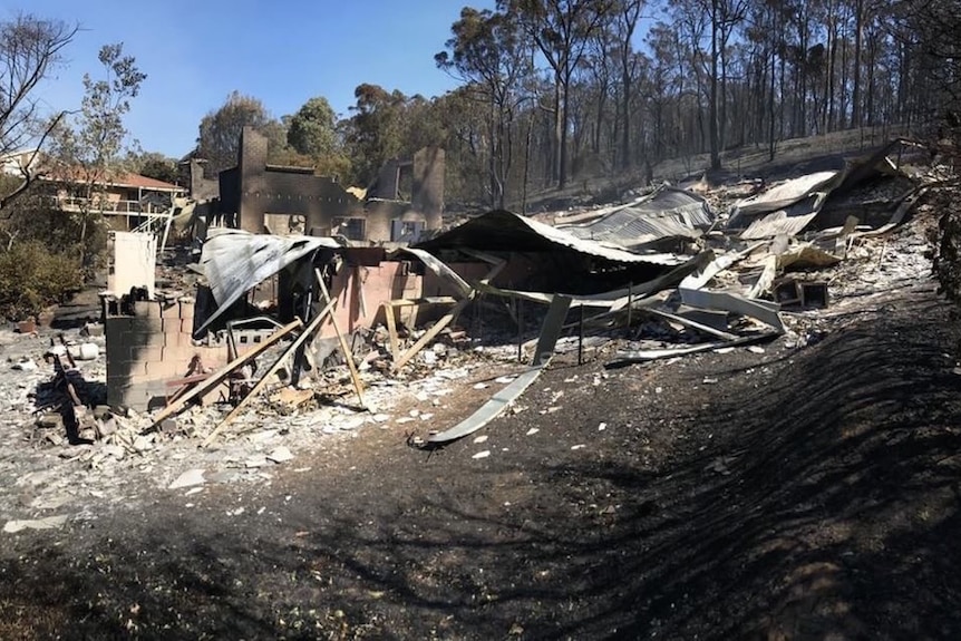 house remains - corrugated iron and rubble