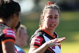 Kezie Apps gestures to his Wests Tigers teammates during an NRLW game.