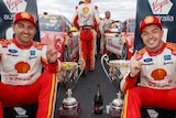 Supercars driver Scott McLaughlin and Fabian Coulthard stick their index fingers in the air.