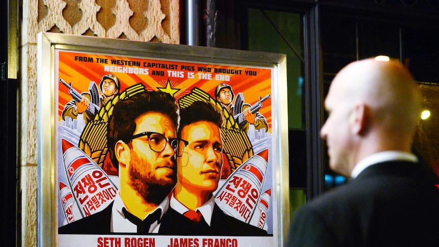 A security guard stands at the entrance of United Artists theatre during the premiere of the film "The Interview" in Los Angeles