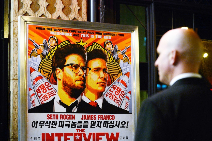 A security guard stands at the entrance of United Artists theatre during the premiere of the film "The Interview" in Los Angeles