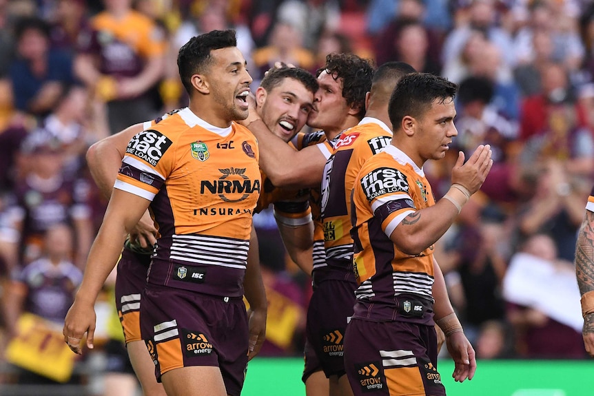 The Broncos celebrate a Corey Oates try.
