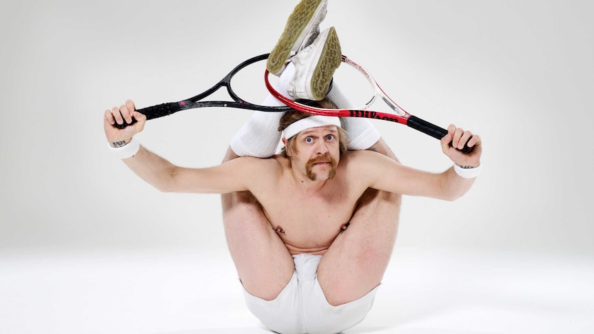 Contortionist posing with tennis rackets