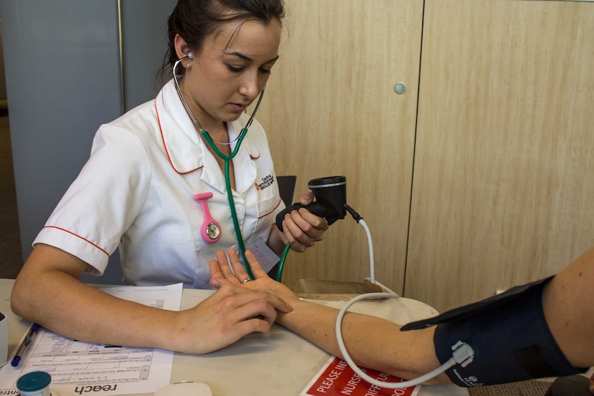 A nurse taking a patient's blood pressure.