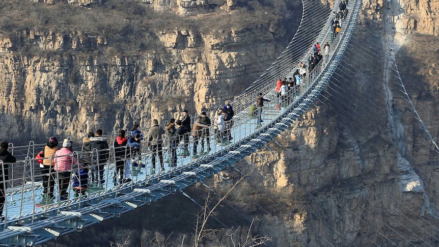 Visitors walk along the 488 metre long suspension bridge in Heibei province.