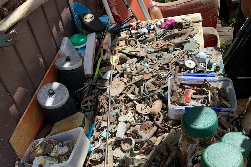 A collection of rusty metal objects on a table, December 2020.