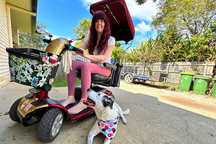 A smiling young woman on a mobility scooter.