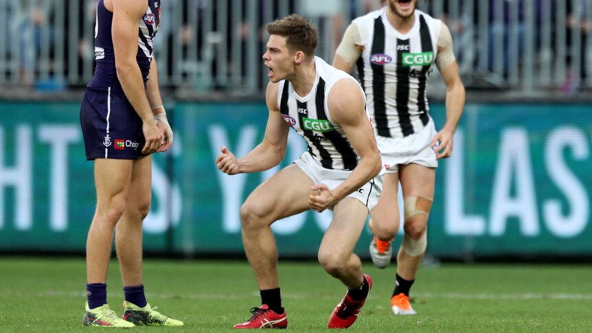 Josh Thomas of the Magpies celebrates after kicking a goal against Fremantle.