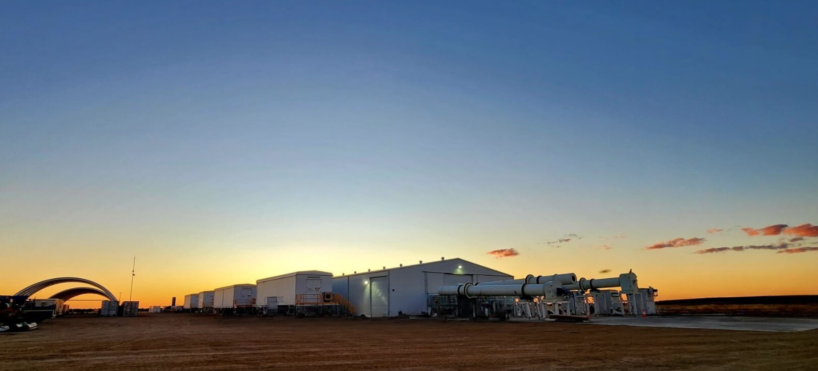 A resources centre in the middle of outback Queensland with a sunset behind it.