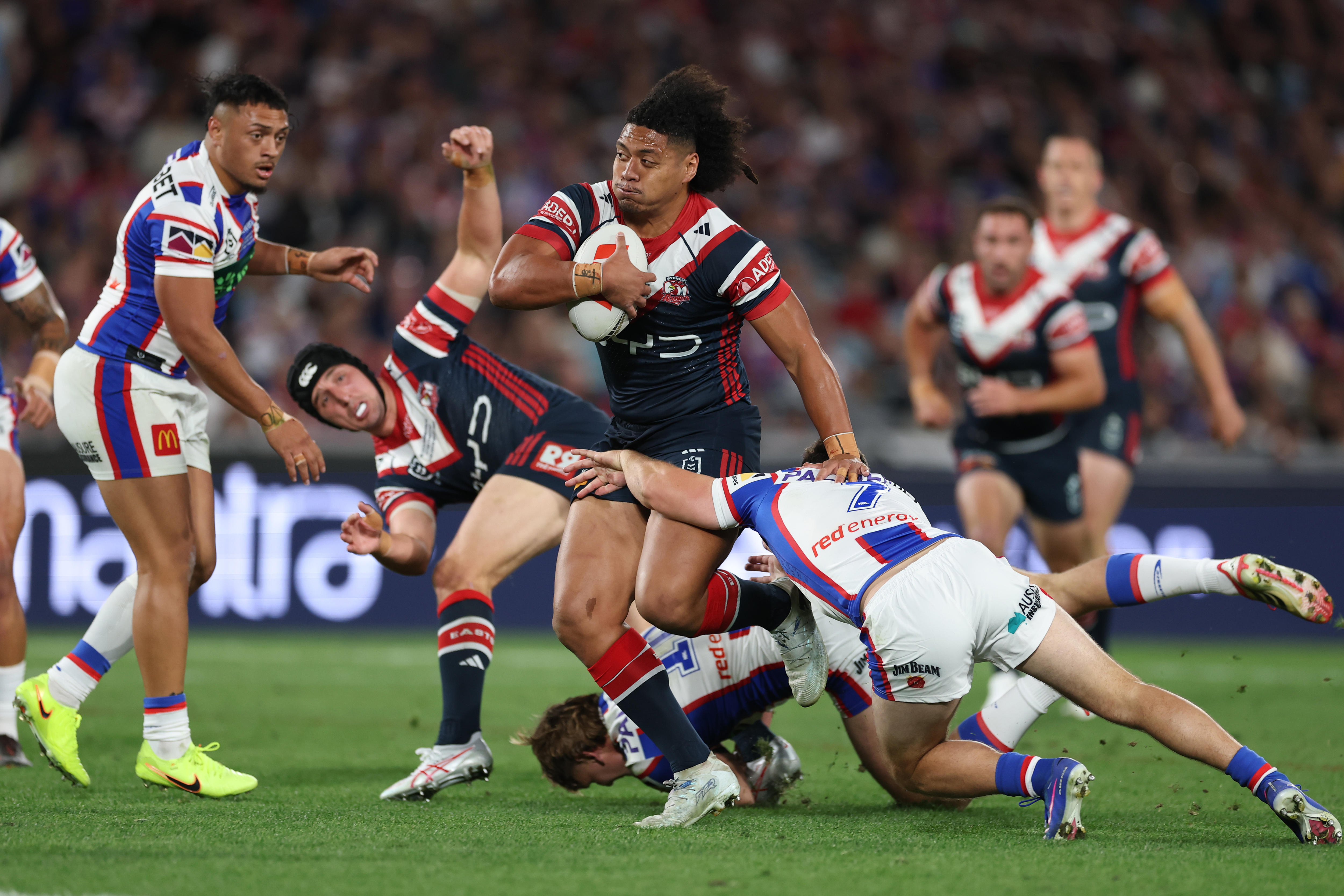 A man runs the ball during a rugby league match