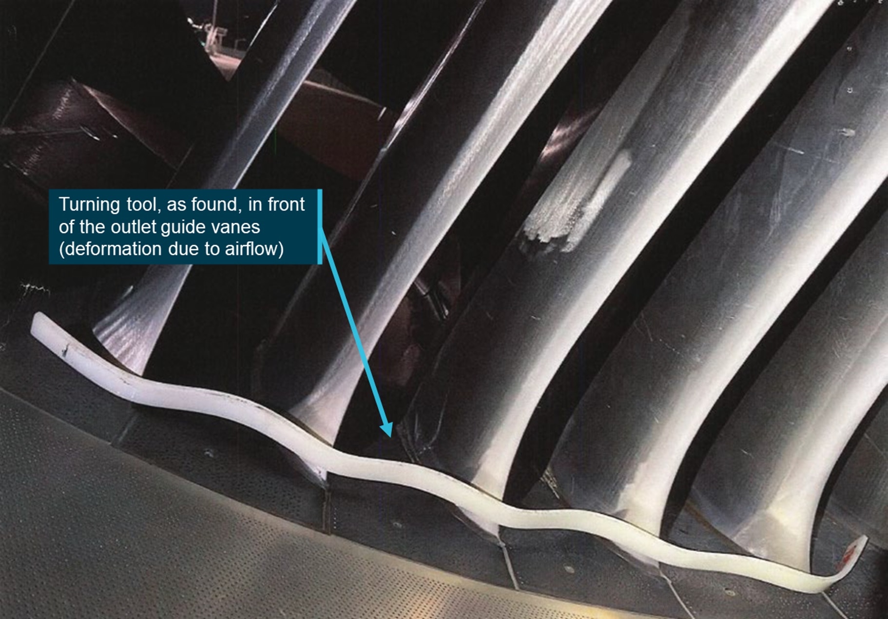 Close up of a turning tool in front of outlet guide vanes.