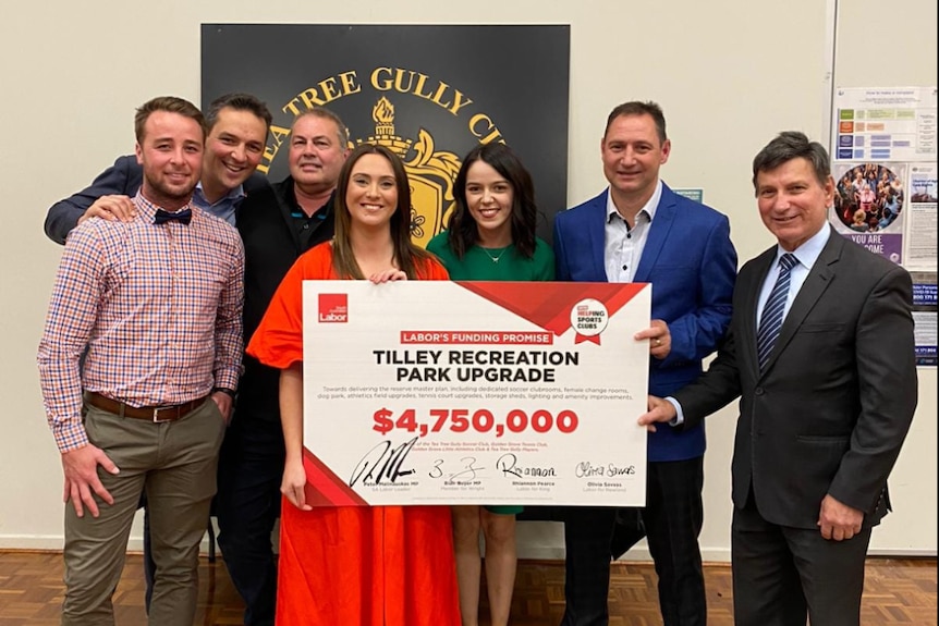 Seven people holding a giant cheque addressed to the Tilley Recreational Park