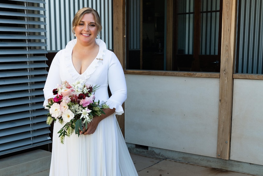 A smiling bride in a wedding dress made of wool