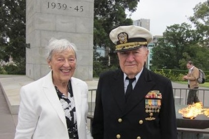 CMDR Herb Kriloff, standing at the Melbourne Shrine of Remembrance, with a lady