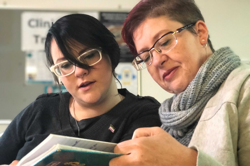 Jen and Denise read a journal.