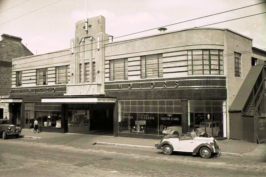 Sepia-coloured photo of an art deco building with Metro Motors written on it