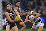Toby Green makes a handpass against Geelong during the 2024 AFL season.