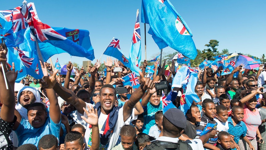 Fans greet Fiji's Olympic gold-medal-winning men's sevens rugby team.