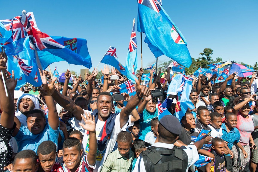 Fans greet Fiji's Olympic gold-medal-winning men's sevens rugby team.