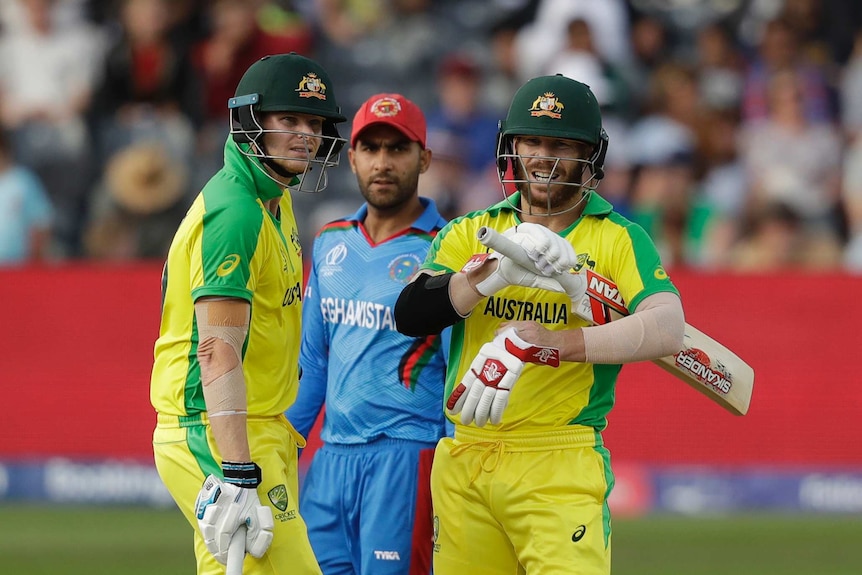 Steve Smith stands next to David Warner as they survey Afghanistan's field placements during a World Cup match