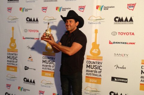 Country music singer Lee Kernaghan with one of his Golden Guitars