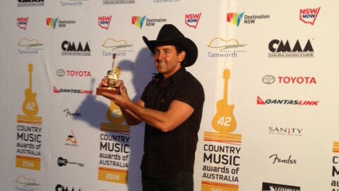 Country music singer Lee Kernaghan with one of his Golden Guitars