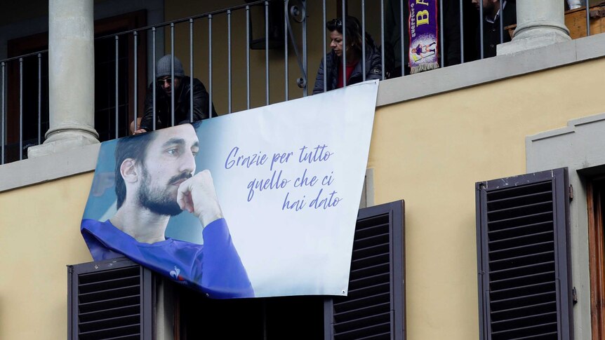 Fiorentina fans hang a banner of Davide Astori during his funeral service.
