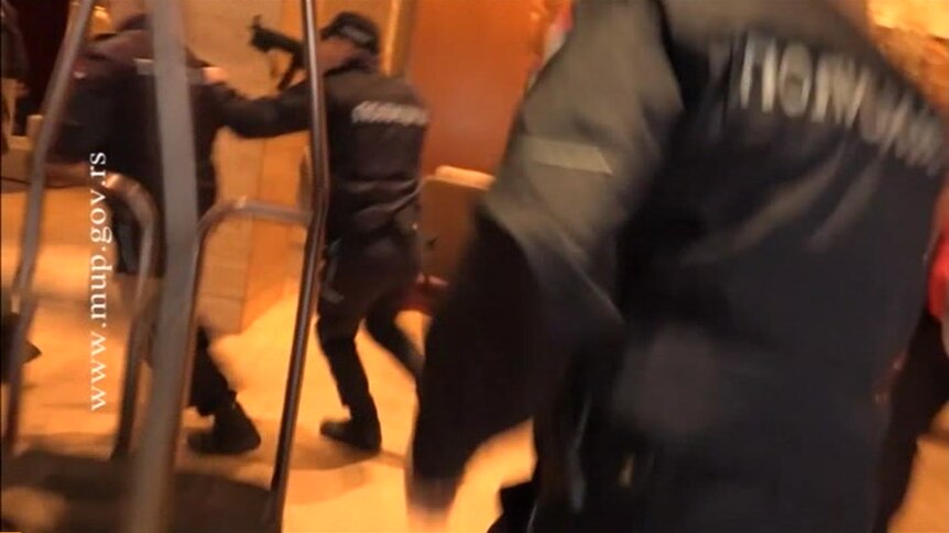 Police armed with automatic rifles in a hotel lobby