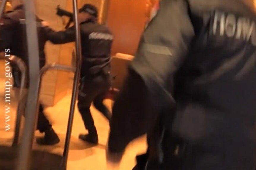 Police armed with automatic rifles in a hotel lobby
