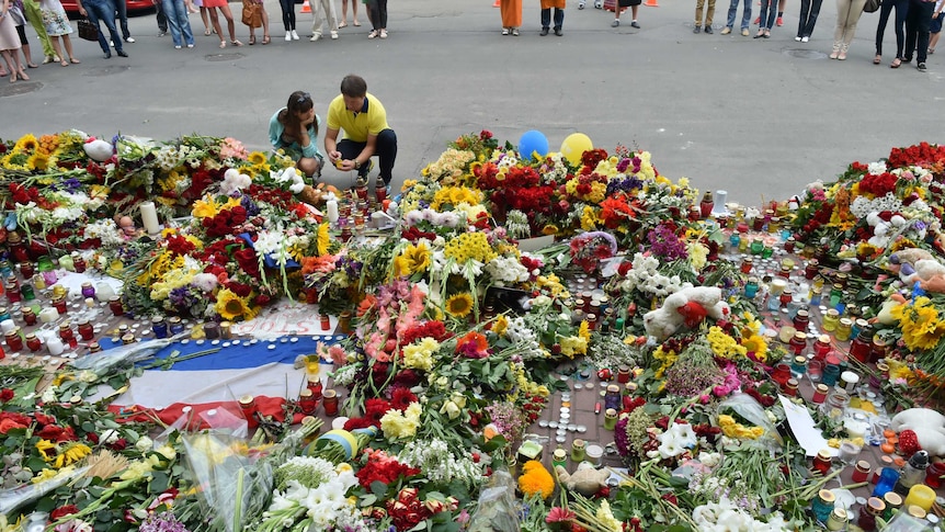 People lay flowers in Kiev for victims of downed flight MH17