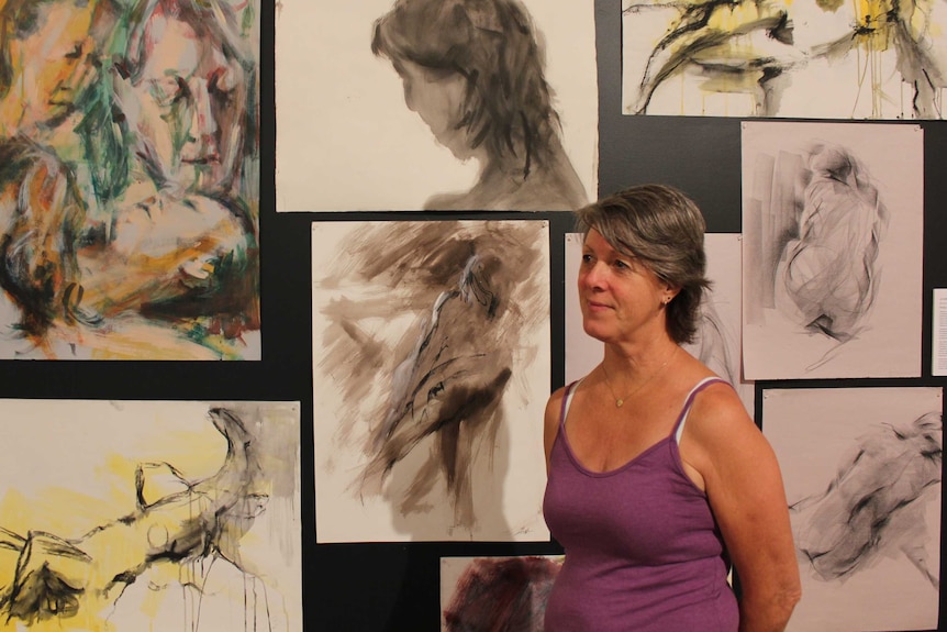 Life Model Louise Harrison standing in front of body of work.