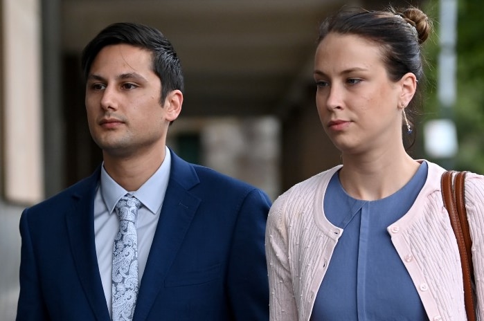 A man and a woman walking, holding hands