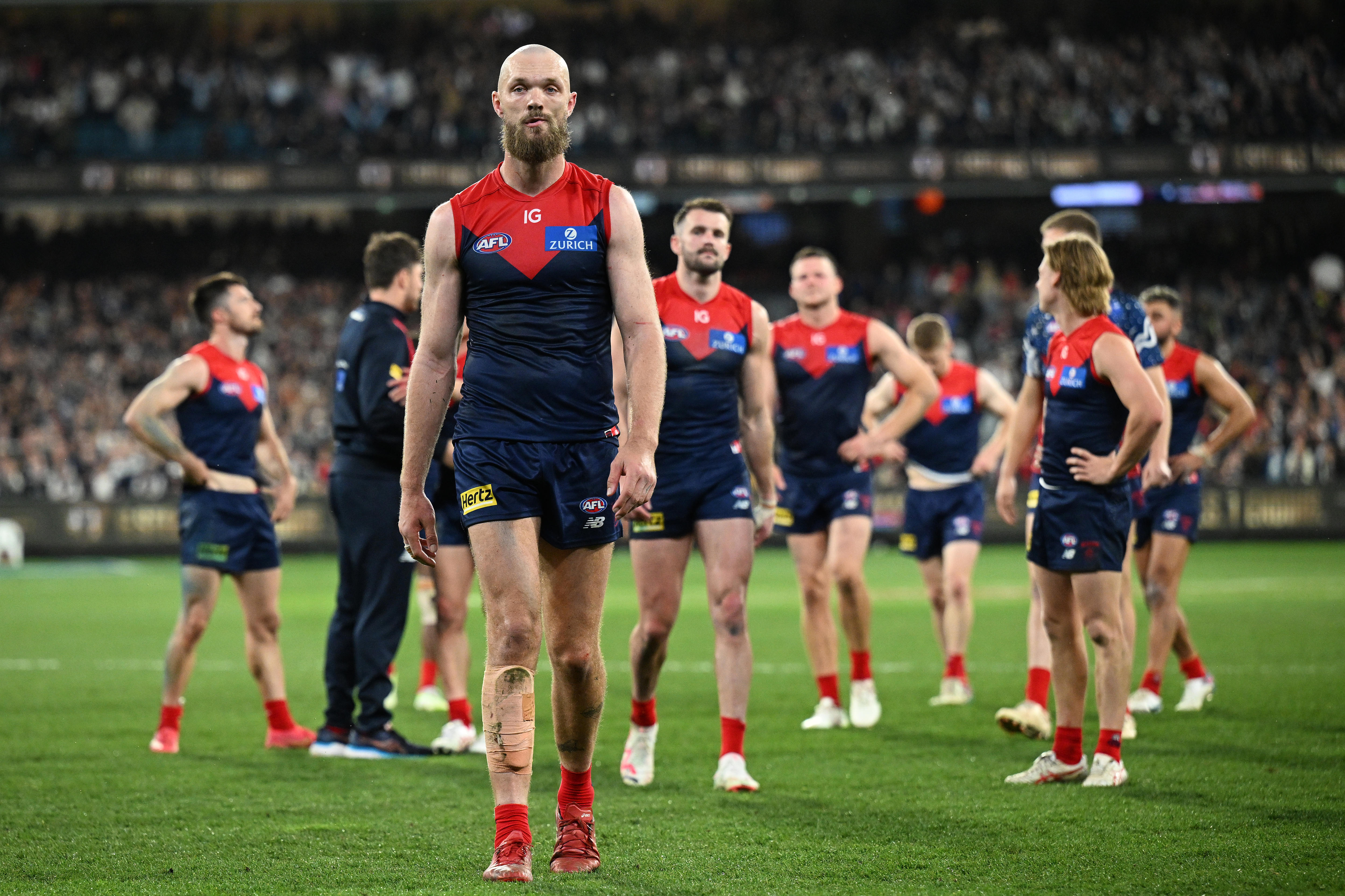 Melbourne's AFL captain, Max Gawn looks dejected as he walks off the ground ahead of his team after a loss. 