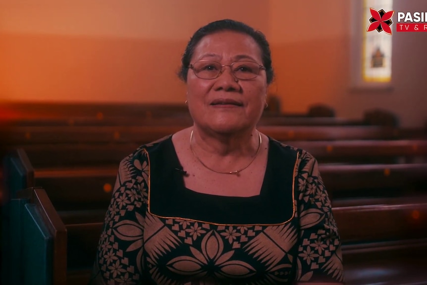 A screenshot of Aii Aiga sitting at church from a video,