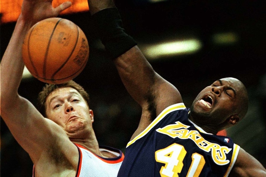 Lakers player Glen Rice and Phoenix player Luc Longley battle for basketball