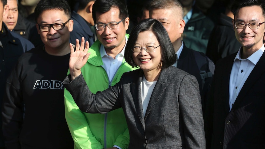 Smiling and waving, Taiwanese President Tsai Ing-wen at a polling station.