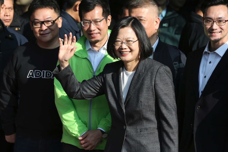 Smiling and waving, Taiwanese President Tsai Ing-wen at a polling station.