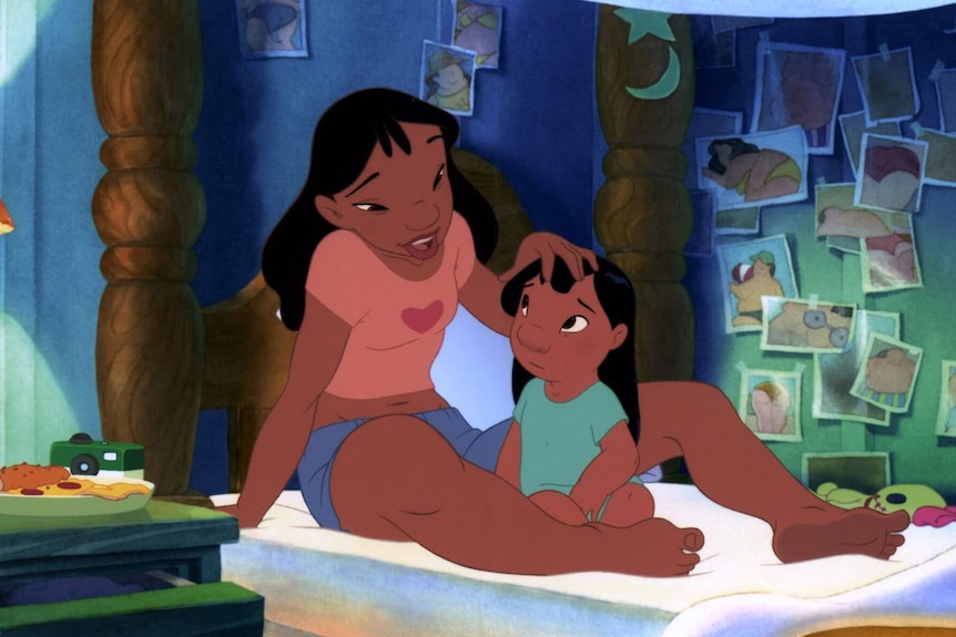 Cartoon character Nani sits on the bed with younger sister Lilo in a dimly lit bedroom. Pictures hang on the wall.