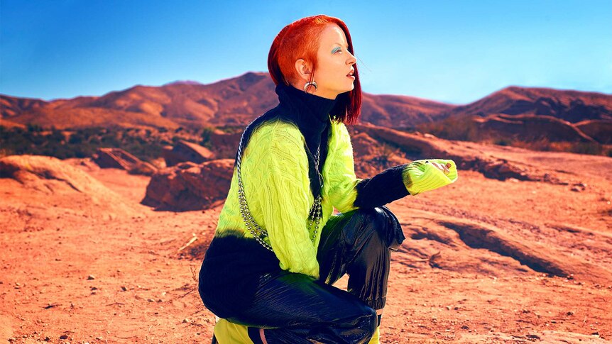 Garbage frontwoman Shirley Manson crouches in the desert