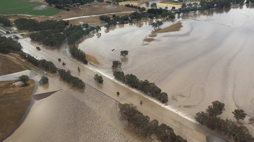 Aerial image of expansive brown floodwaters.