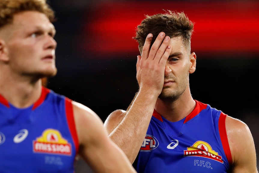 Josh Dunkley puts a hand over his eye while looking frustrated