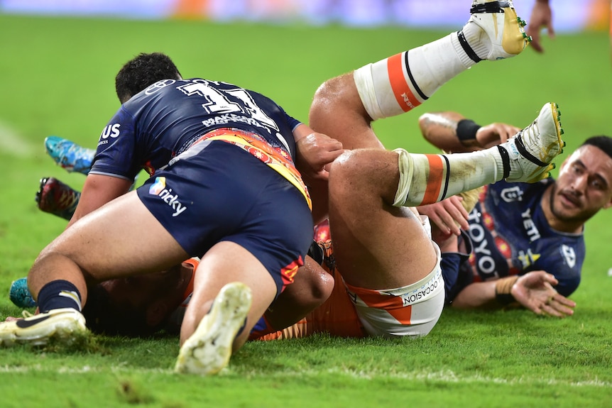 Isaiah Papali'i is tackled by Valentine Holmes
