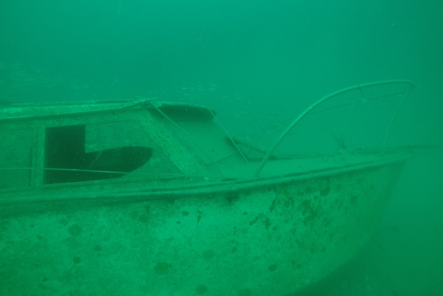 A boat on the bottom of a green sea