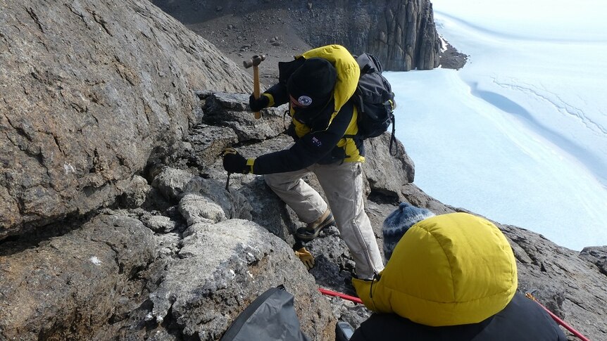 Dr Marcus Salton obtains sample of mumijo off rocks.