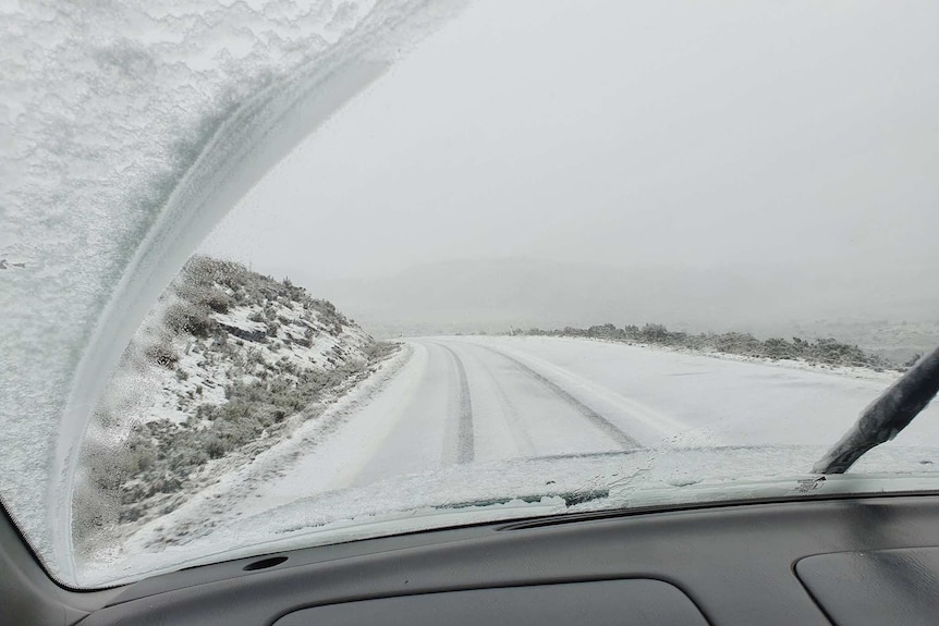 The view through the windscreen on snowy roads on Tasmania's west coast.