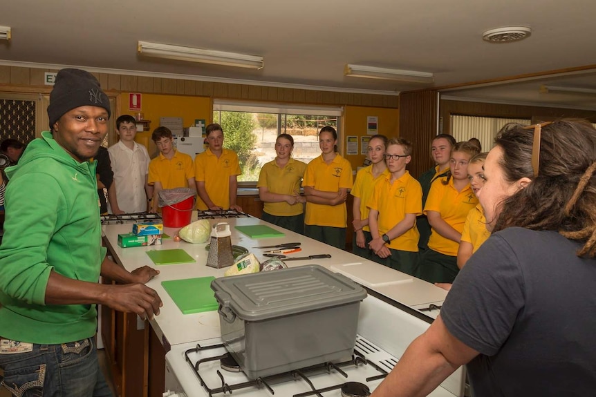 A man about to cook with high school students