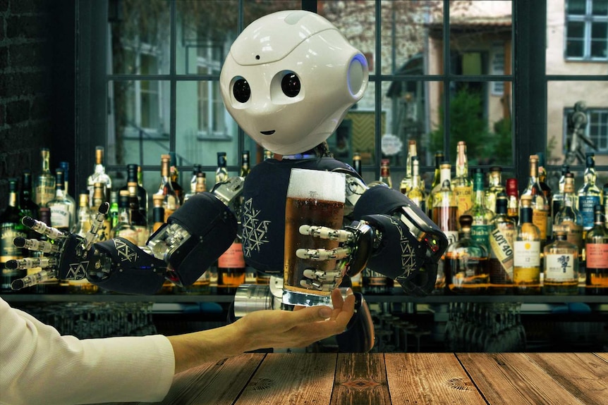 A robot serves a glass of beer from behind a fully-stocked bar.