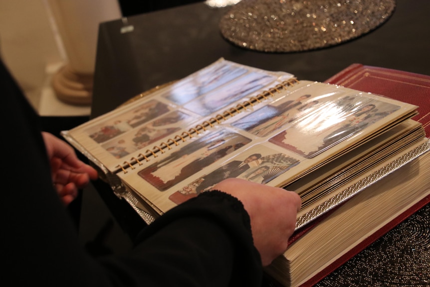 hands flick through a photoalbum with wedding photos