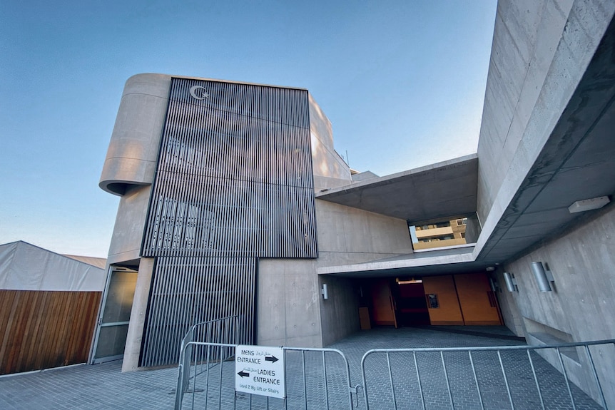 The entrance to Punchbowl Mosque includes signage directing people to womens and mens entrances.