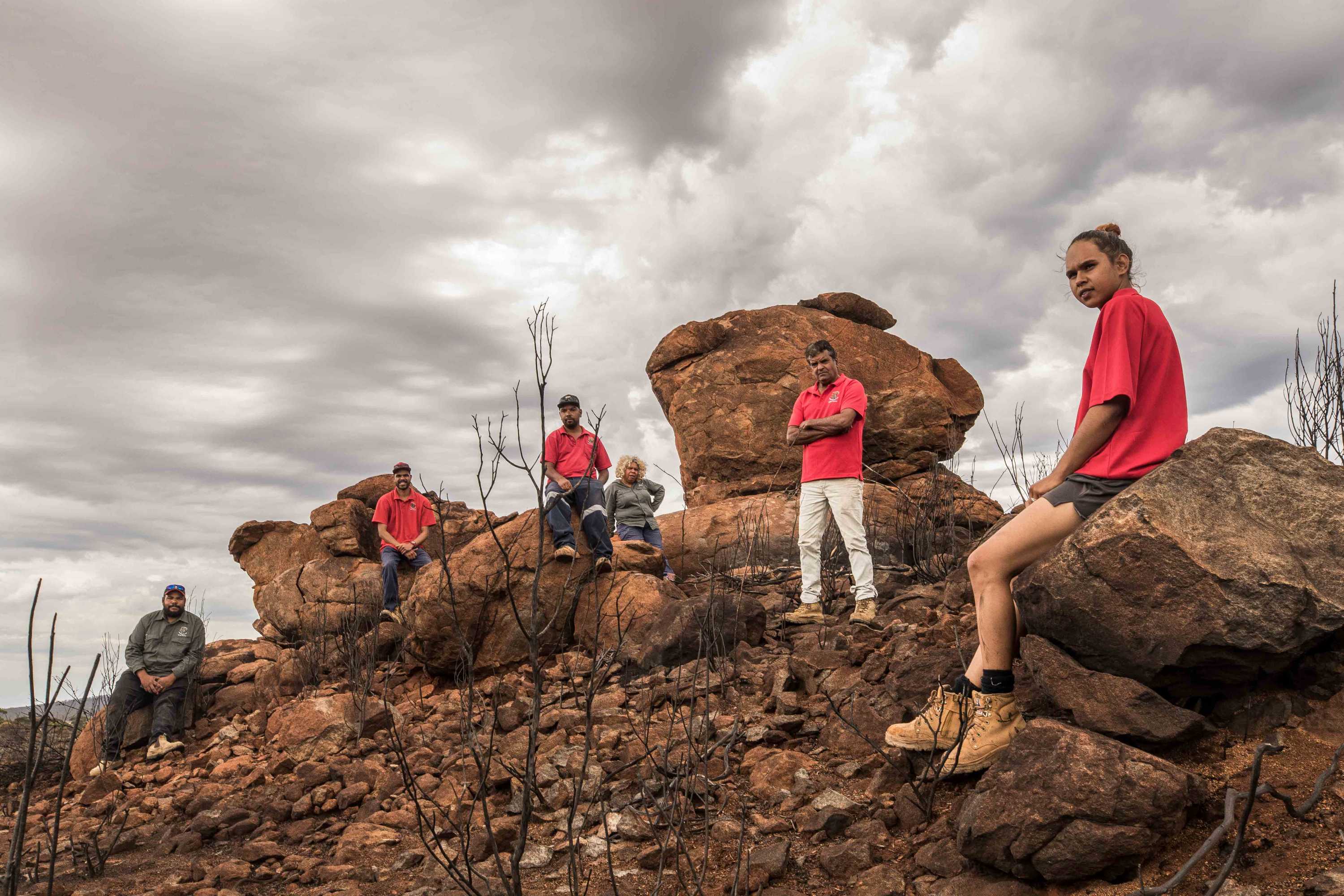 Aboriginal people on their traditional lands after a bushfire.